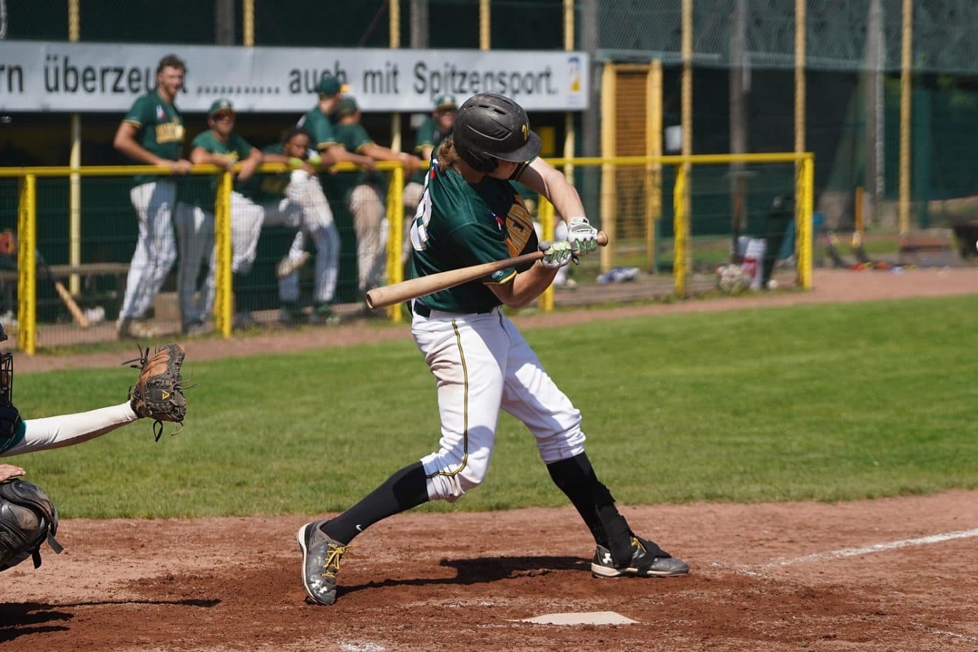 A batter filmed from the side with the whole body in frame